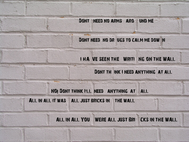 graffiti on a white brick wall