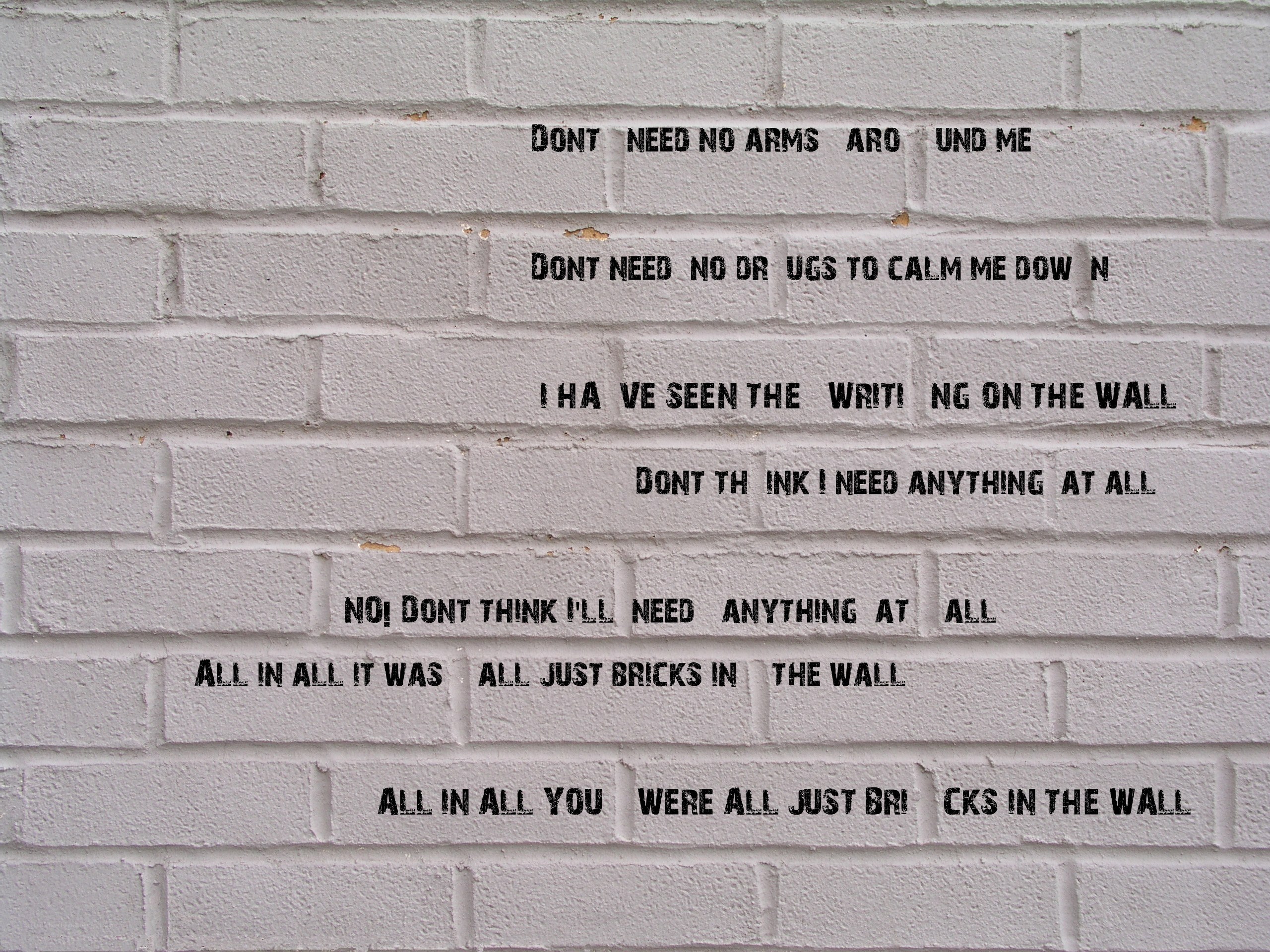 graffiti on a white brick wall