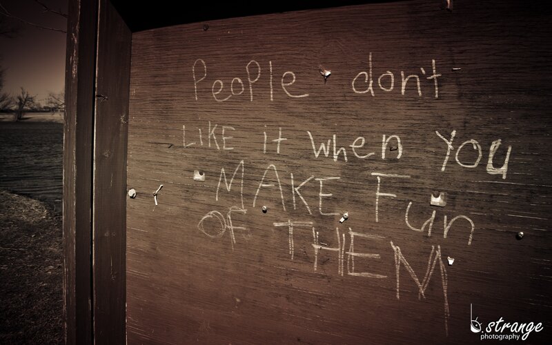 Graffiti on a wooden sign