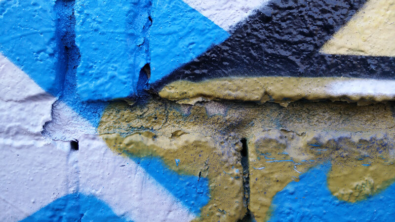 Graffiti on Brick Wall — Blue