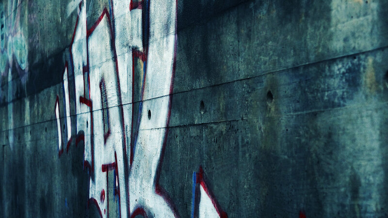 Graffiti on Concrete Wall — Gray, Dramatic, Photograph