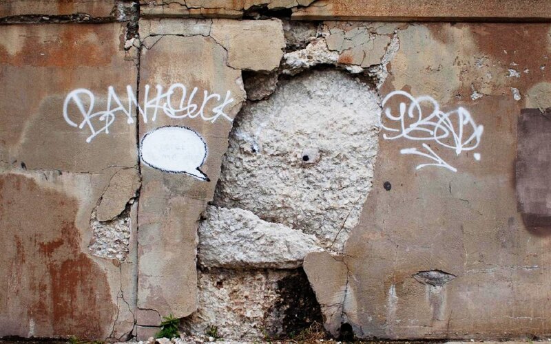Graffiti on Damaged Wall