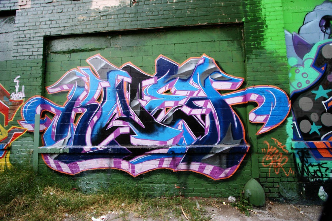 graffiti on green brick wall