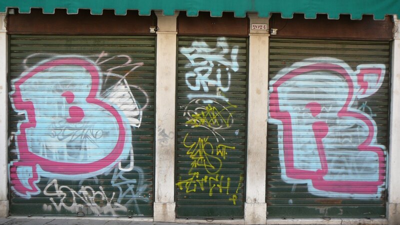 graffiti on shuttered storefronts