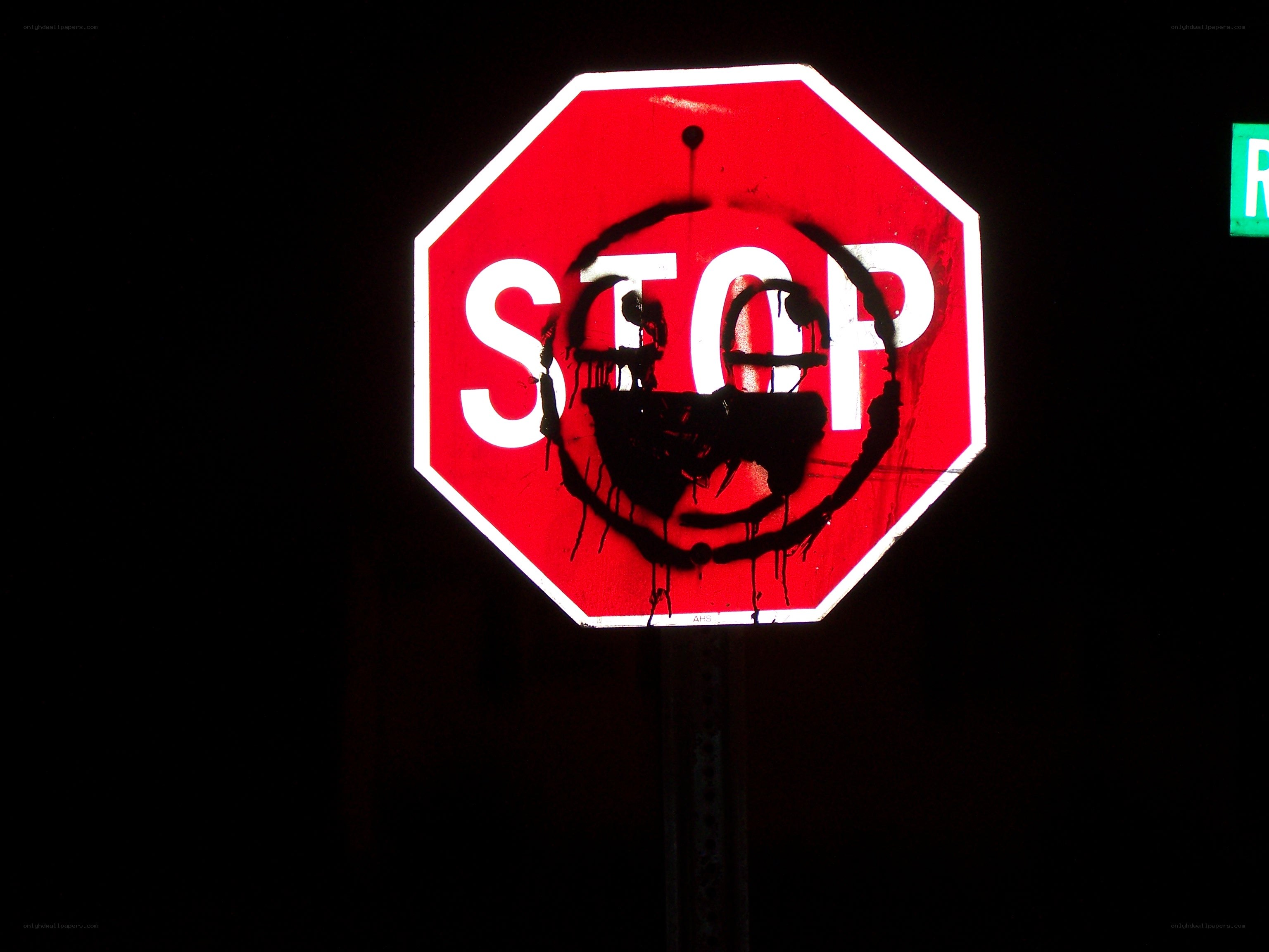 graffiti on stop sign at night