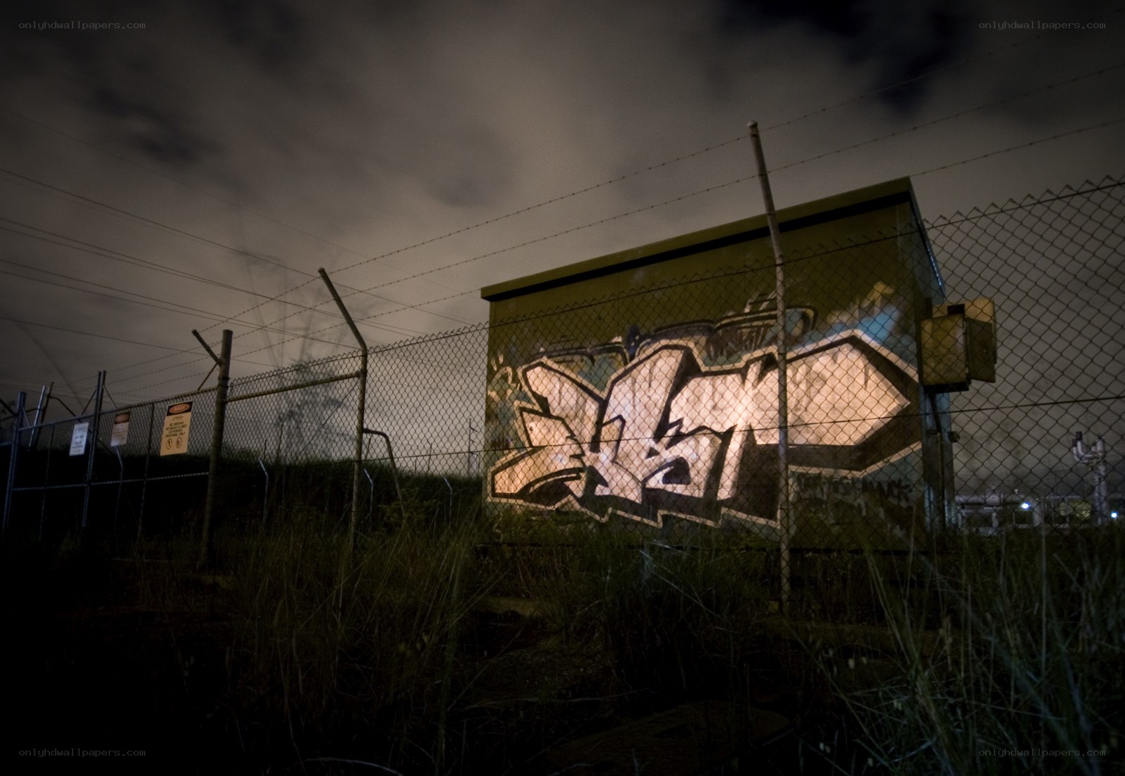 Graffiti on utility box at night