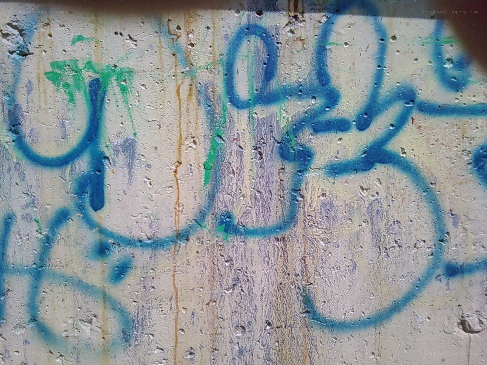 graffiti on wet concrete wall