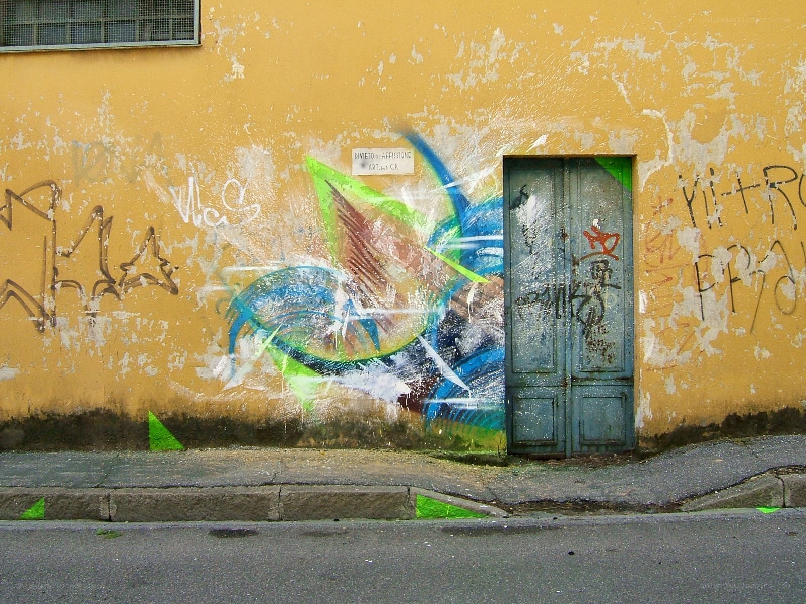 graffiti on yellow wall