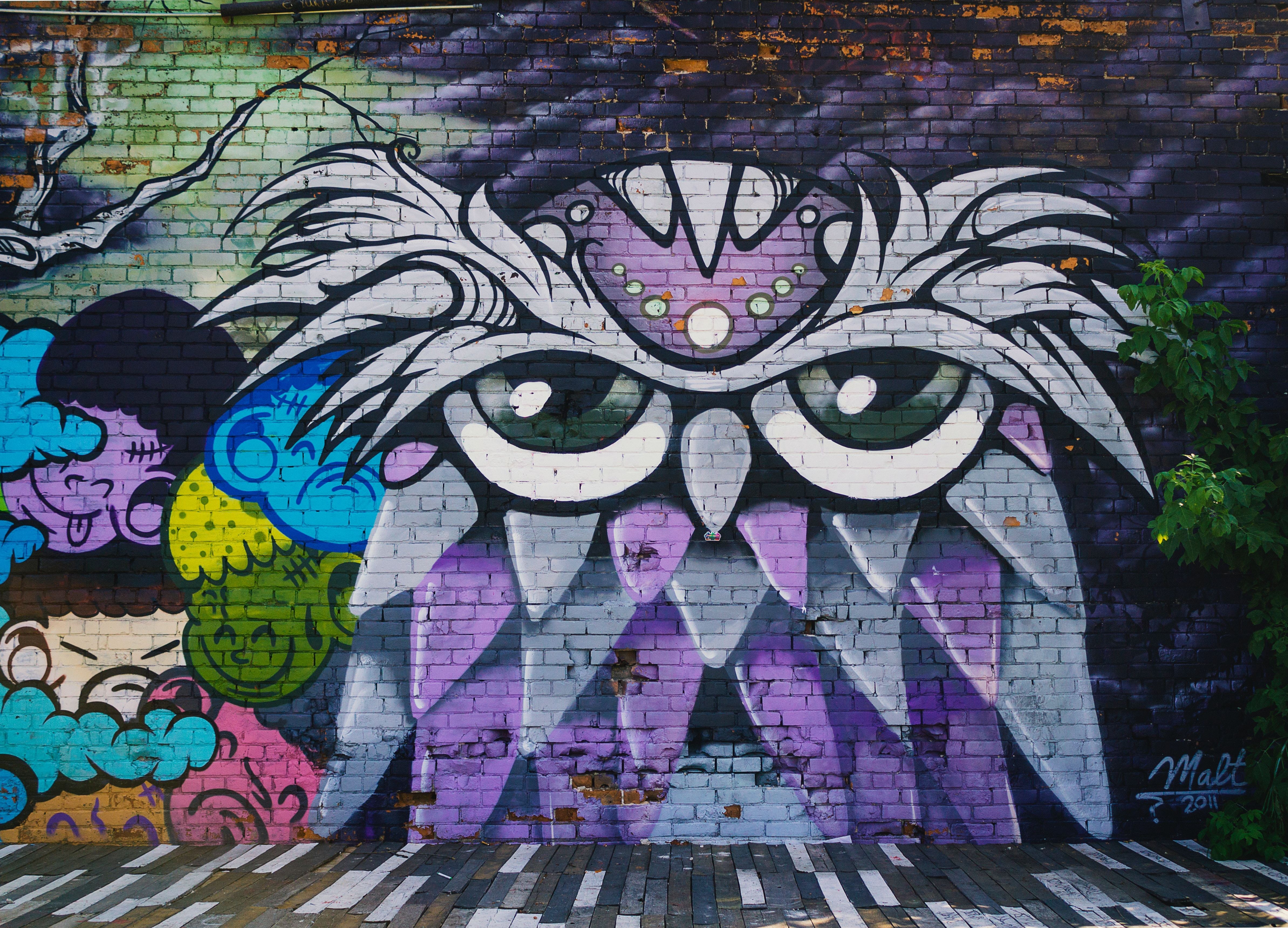 graffiti owl mural on brick wall
