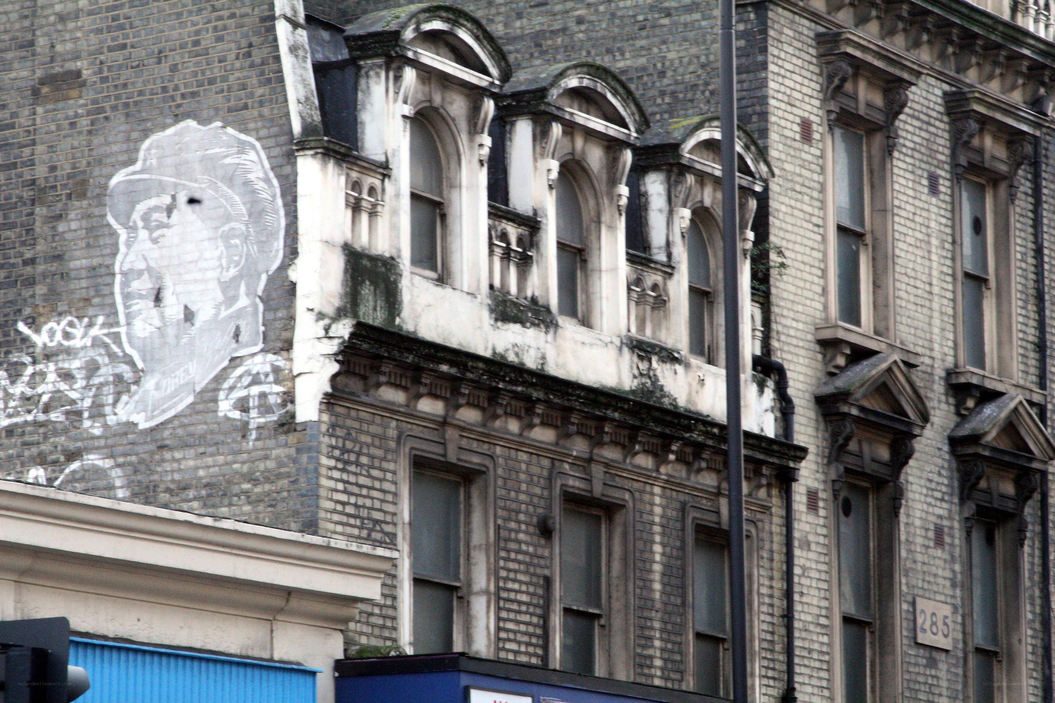 graffiti portrait on brick building