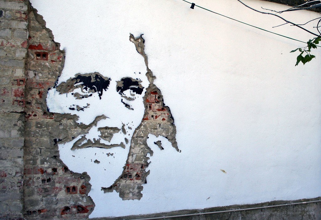 graffiti portrait on damaged wall