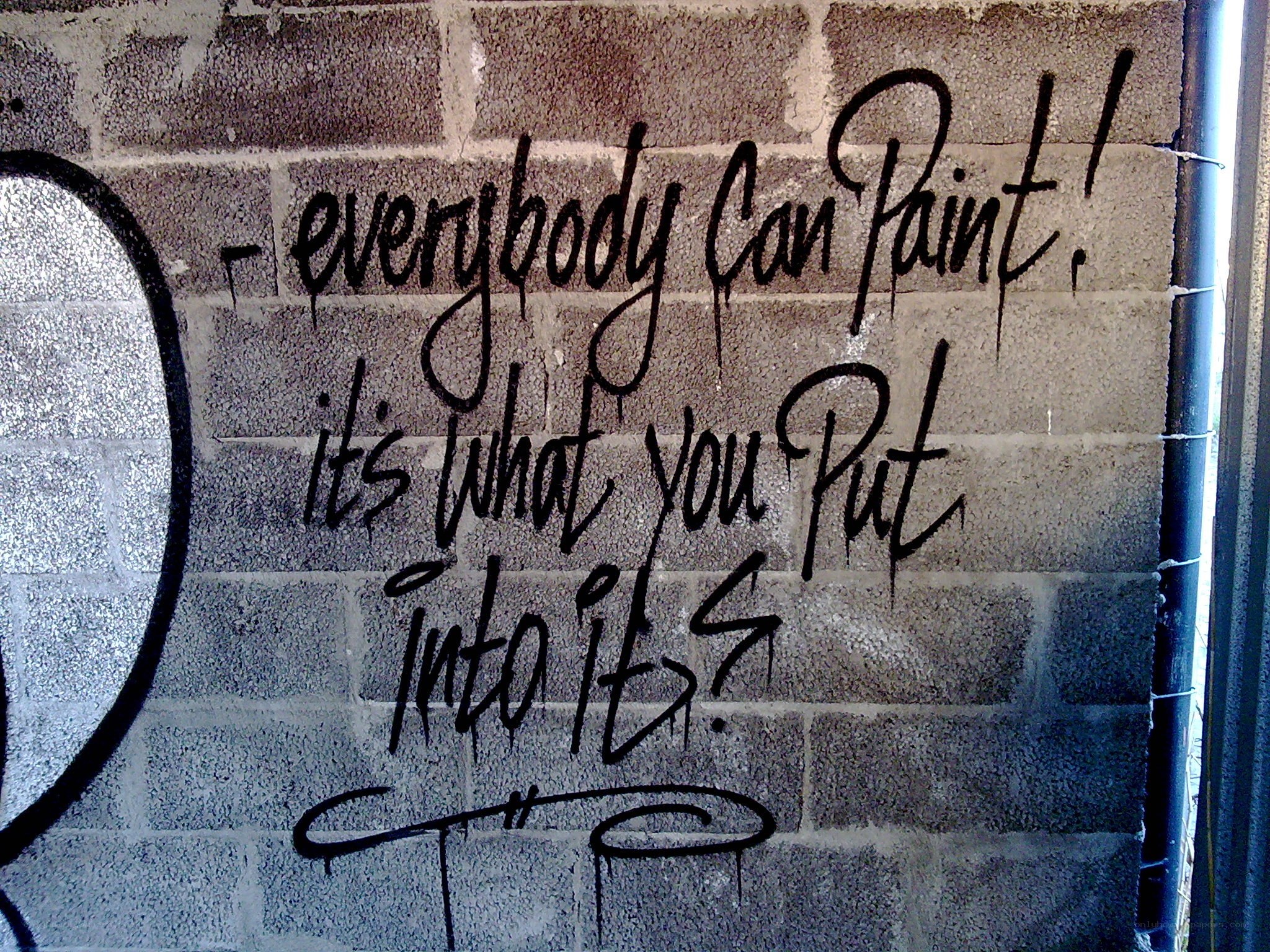 graffiti quote on brick wall