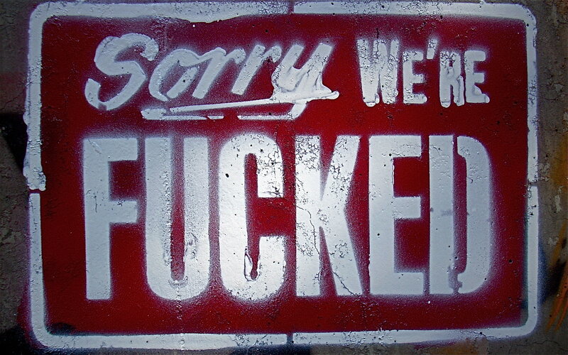 graffiti sign saying 'sorry we're fucked'
