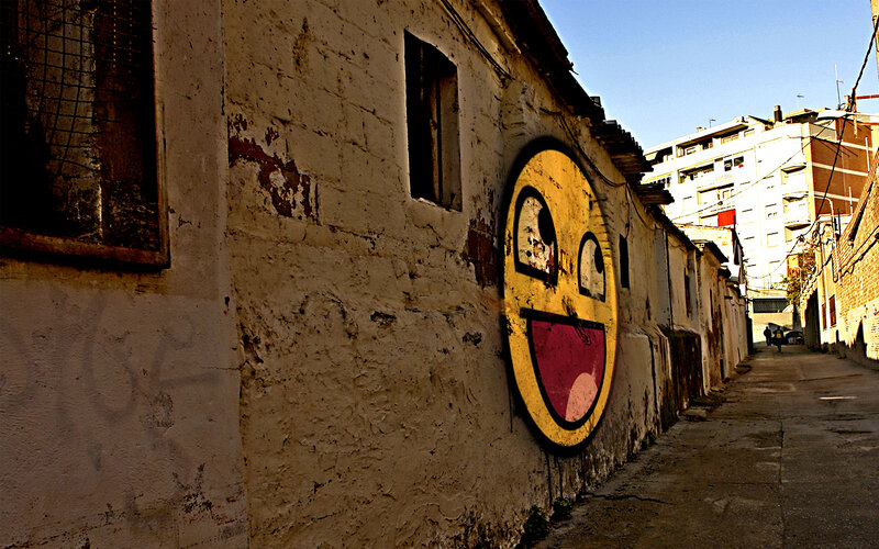 graffiti smiley face in alley