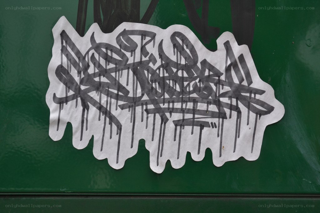 graffiti sticker on green surface
