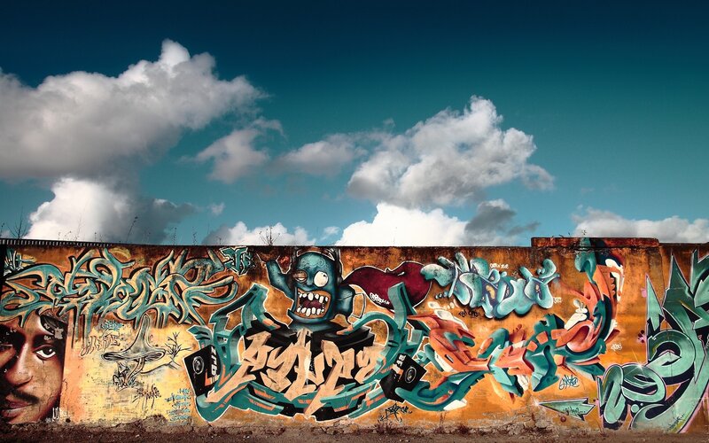 graffiti wall under cloudy sky