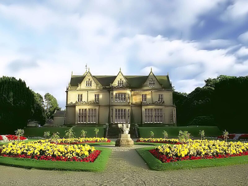 grand manor with flower gardens