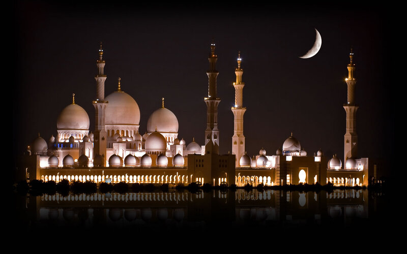 Grand Mosque at night with crescent moon