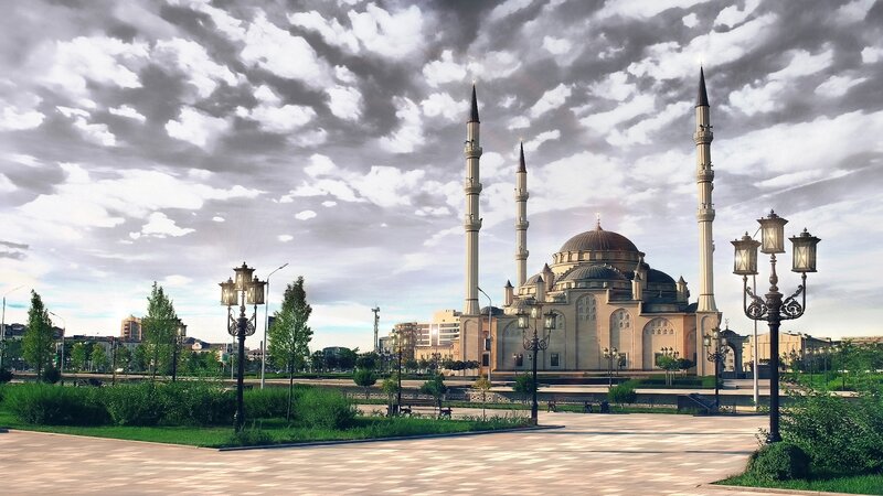 Grand mosque under cloudy sky