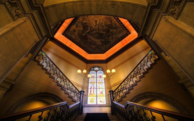 grand staircase with stained glass