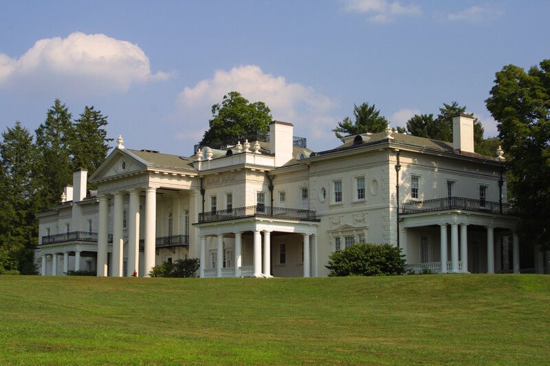 grand white mansion on a hill