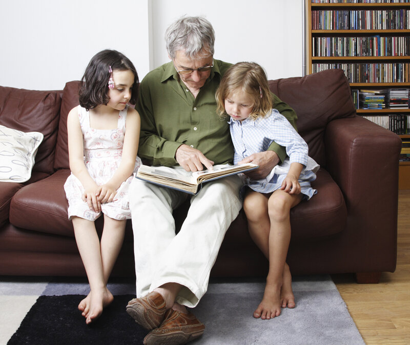 Grandfather Reading to Girls