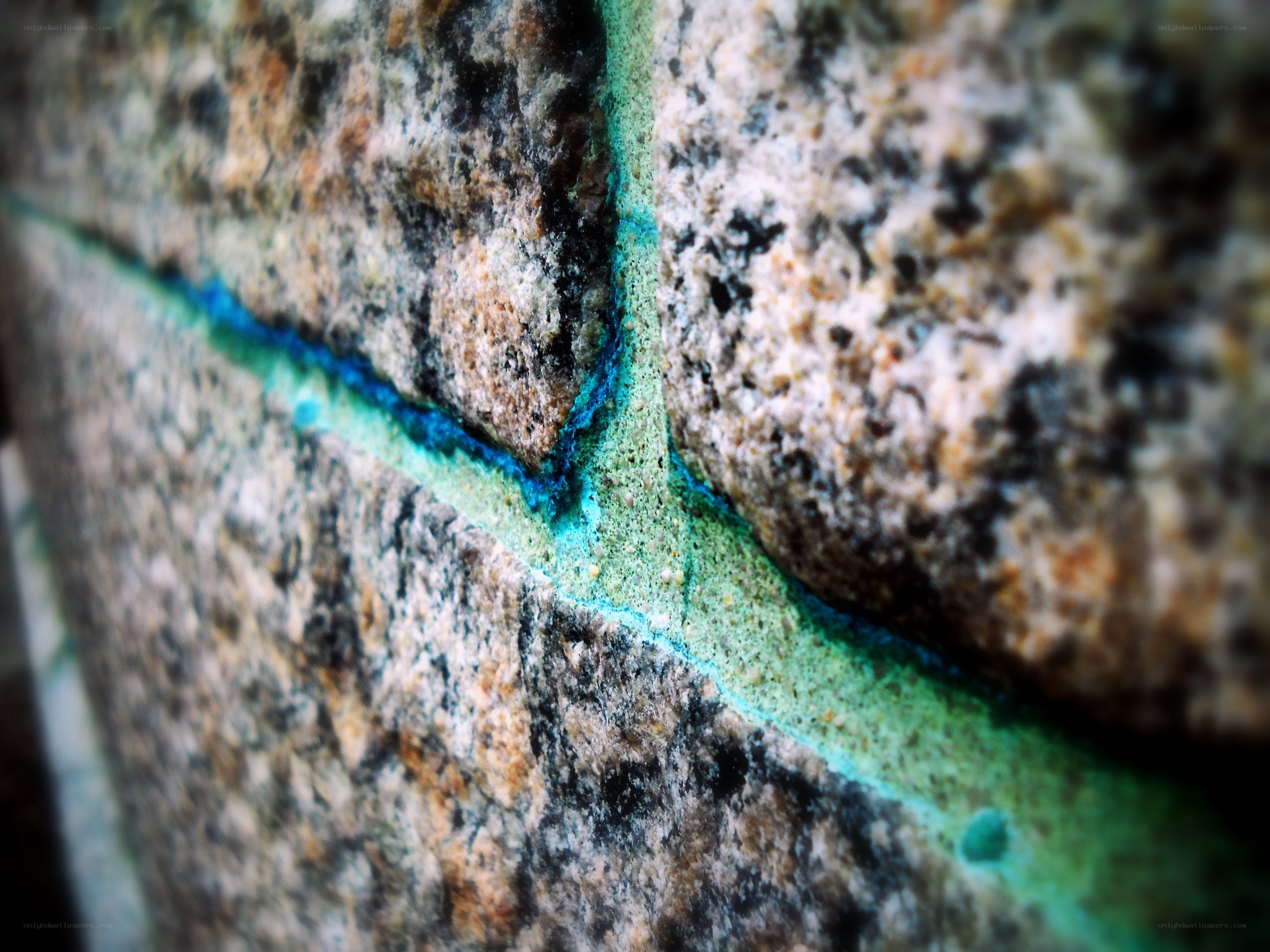 granite wall with blue-green mortar