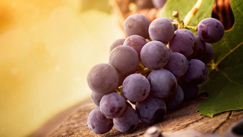 grape cluster on wooden surface