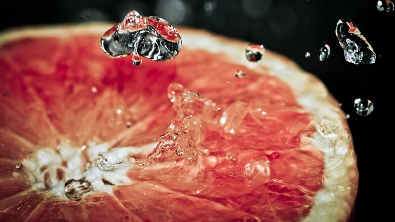 grapefruit slice with water droplets