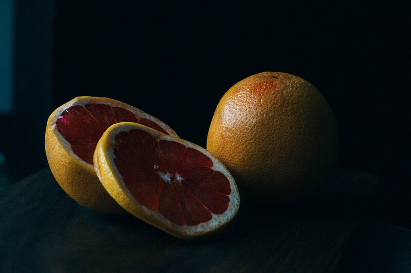 grapefruit slices on dark surface
