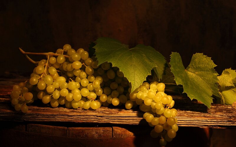 grapes and leaves on wood
