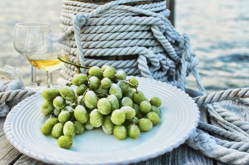 grapes and wine by the water