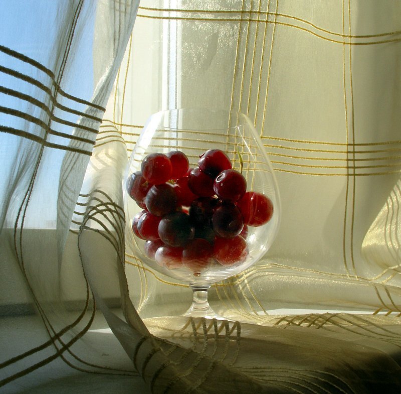 Grapes in a glass on window