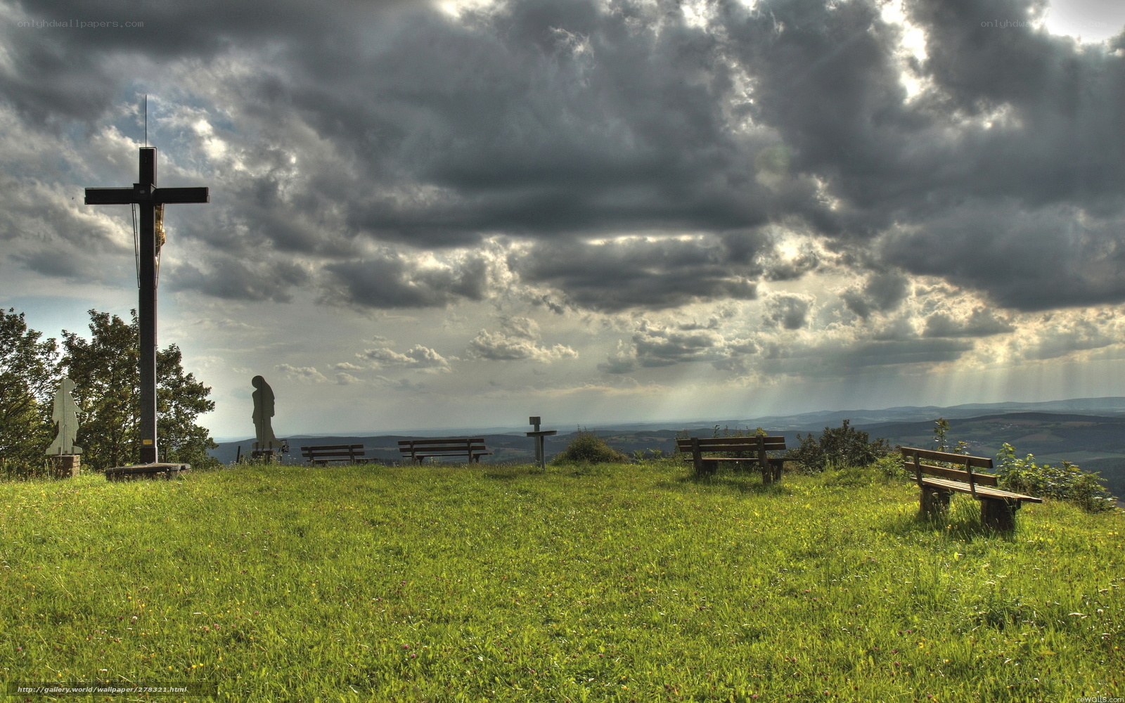Grass field with cross and benches