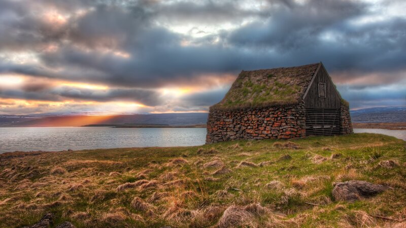 Grass-roofed Hut by Water