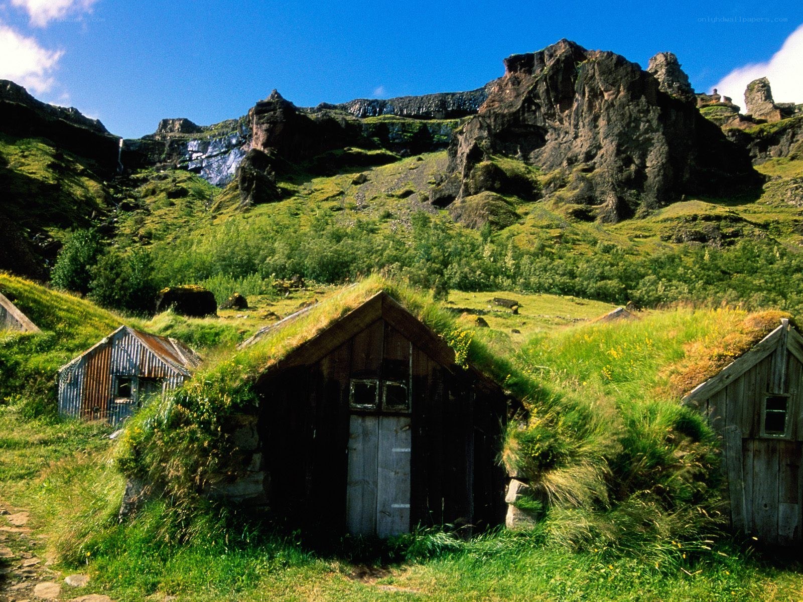 Grass-roofed huts in a mountain valley