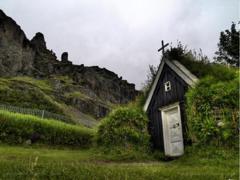 Grassy church by a cliff