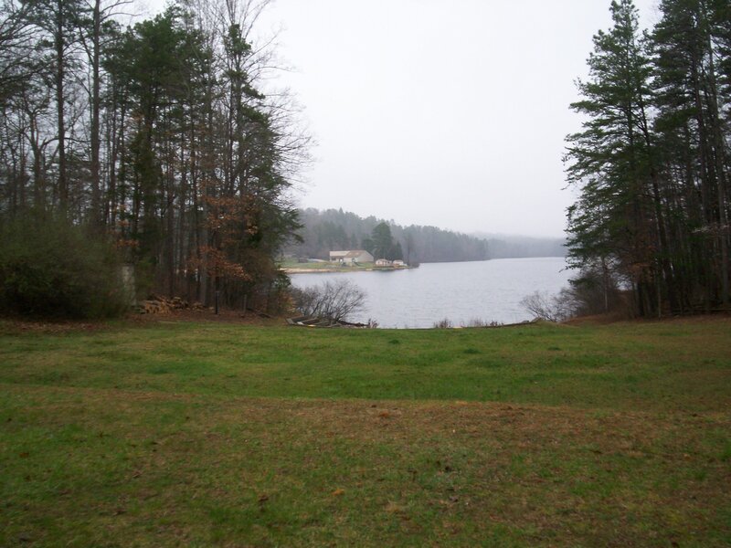 Grassy field overlooking a lake