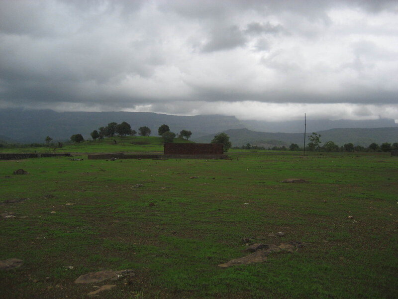 Grassy field with distant hills