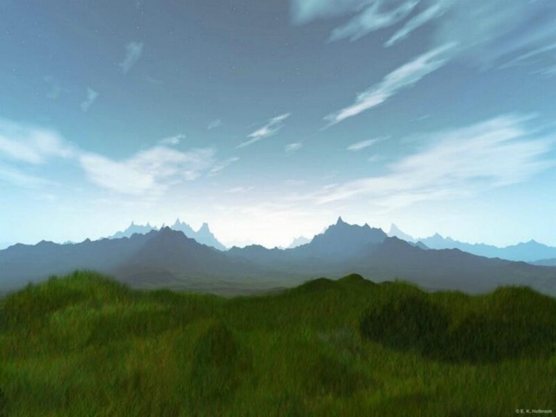 Grassy field with distant mountains