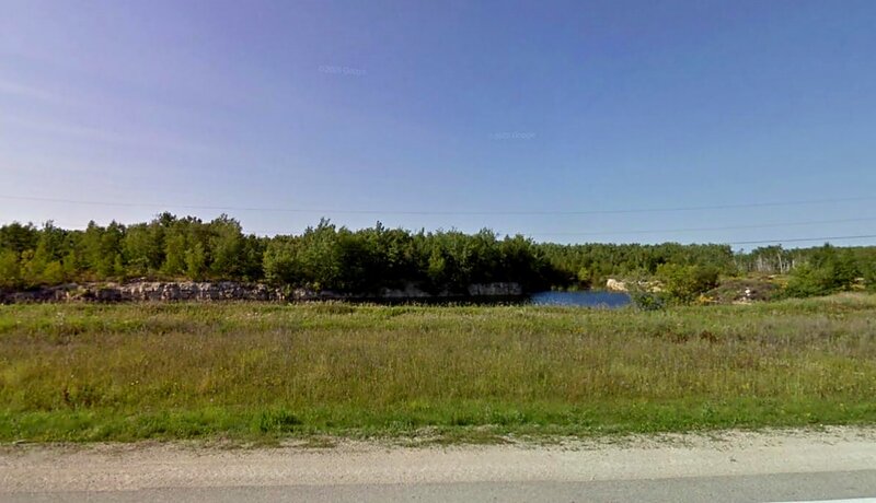 Grassy Field with Pond
