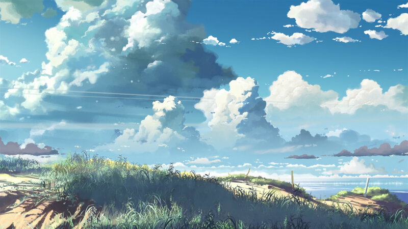 Grassy hill under cloudy sky