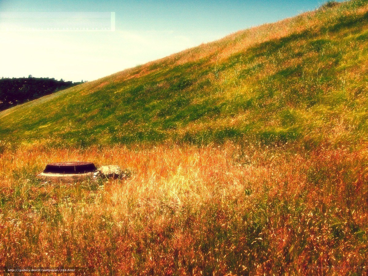Grassy hill with manhole cover