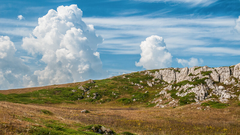 Grassy Hillside with Clouds
