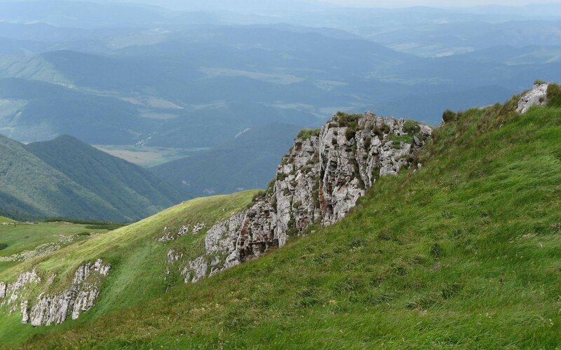 Grassy mountain ridge with cliffs