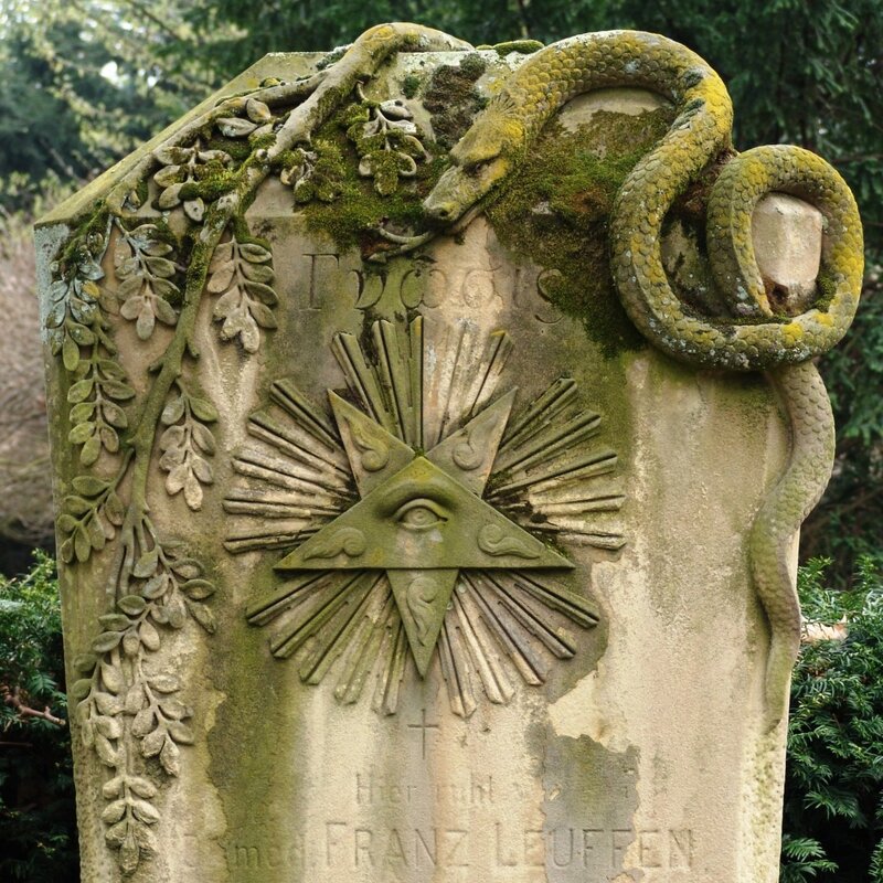 Grave marker with serpent and all-seeing eye
