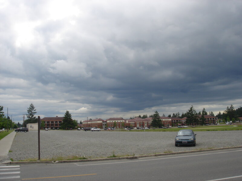 Gravel lot under stormy sky
