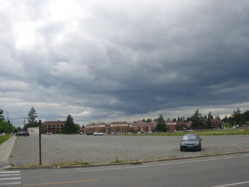 Gravel lot under stormy sky
