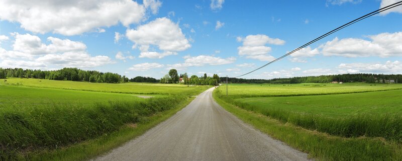 Gravel Road Through Fields — Green, Serene, Afternoon