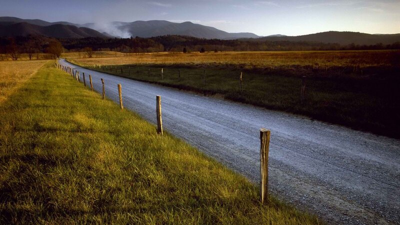 Gravel road through rural valley